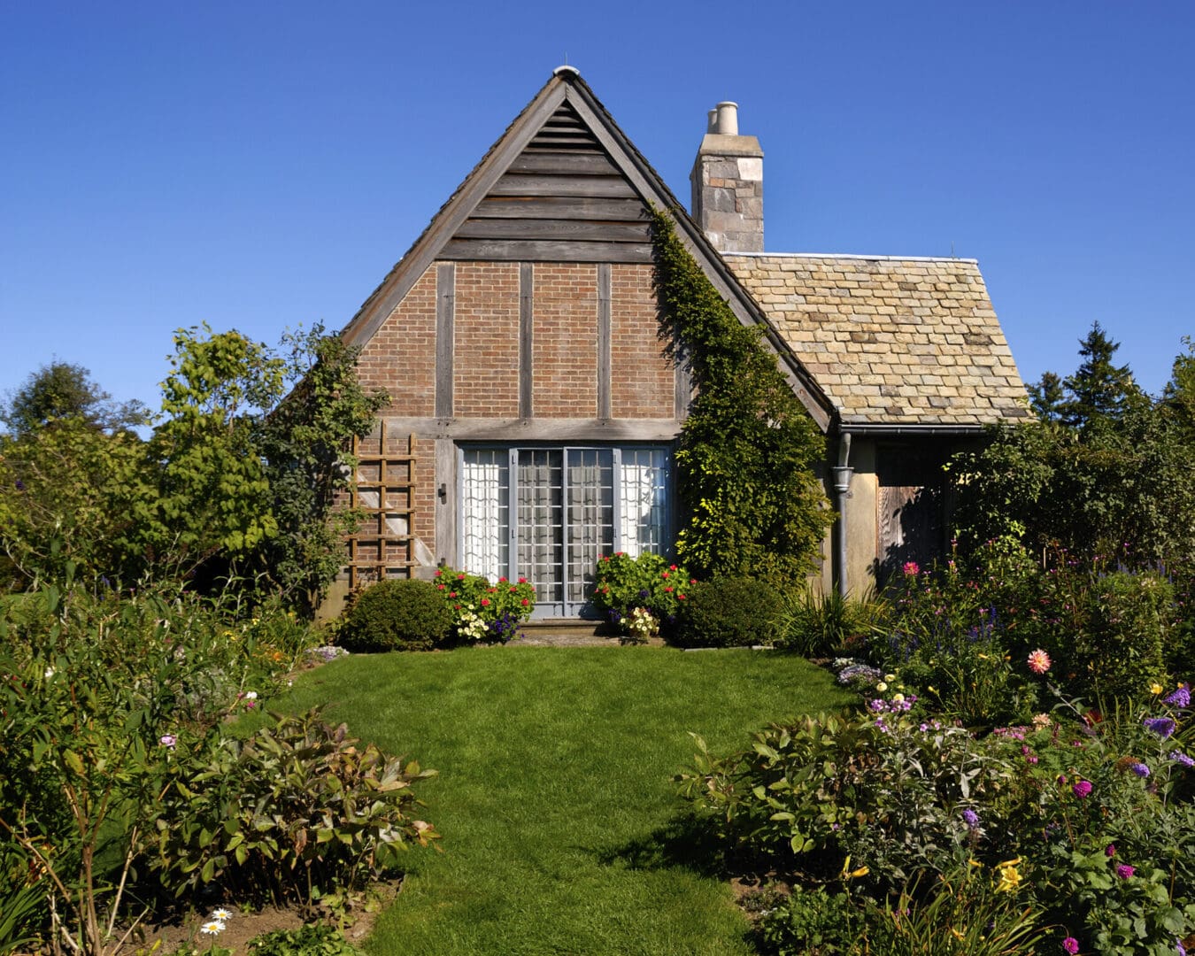 Brick cottage with blooming garden.